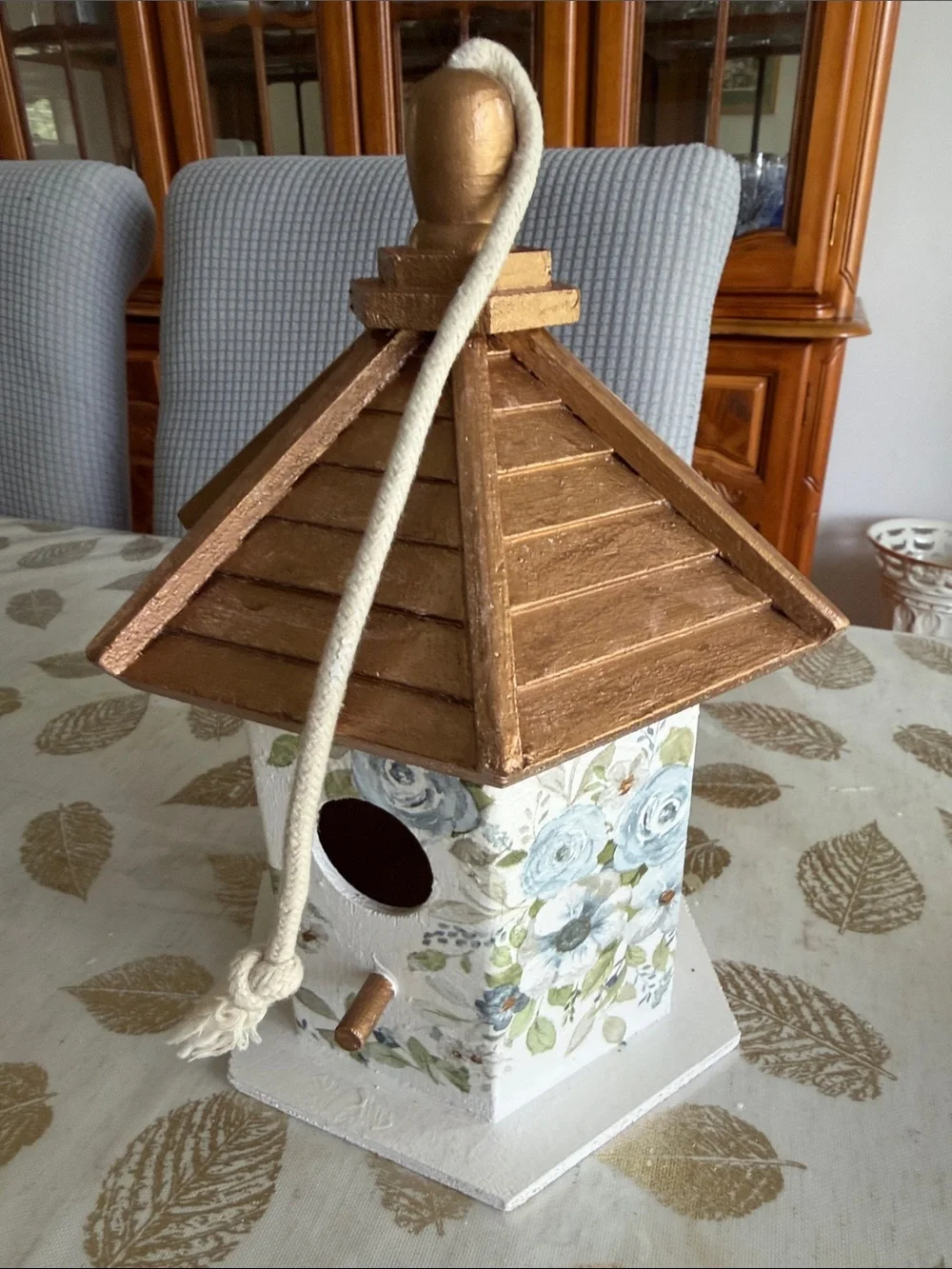 White Birdhouse with Gold Roof and Blue Floral Accents wooden